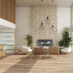 Modern living room with a tall tiled fireplace wall, hanging spherical pendant lights, and mid-century wooden seating around a gas fireplace.