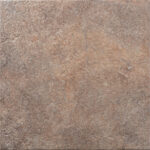 Close-up of a rough, weathered brown stone surface with cracks and a reddish patina.