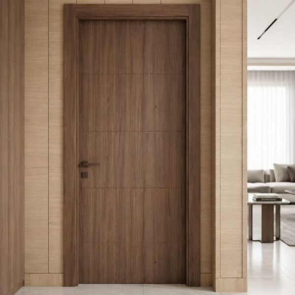 Dark wood interior door set in a light wood-paneled hallway, with a living room and sofa visible through the right doorway behind a partial wall.