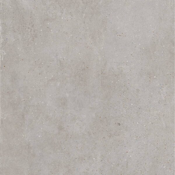 Close-up of a light gray concrete surface with tiny embedded pebbles and subtle staining.
