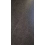 Dark charcoal textured surface resembling concrete or slate panel, vertical orientation.