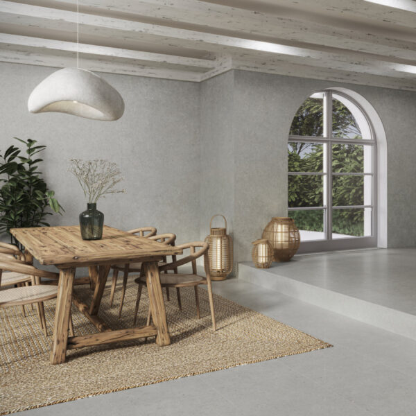 Wooden dining table with six chairs in a bright room, arched window, plants, and wicker lanterns on the floor.